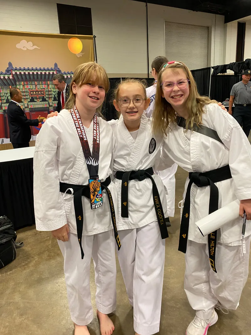 Three black belt students