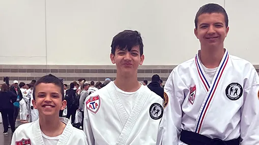 Three junior students with their tournament medals